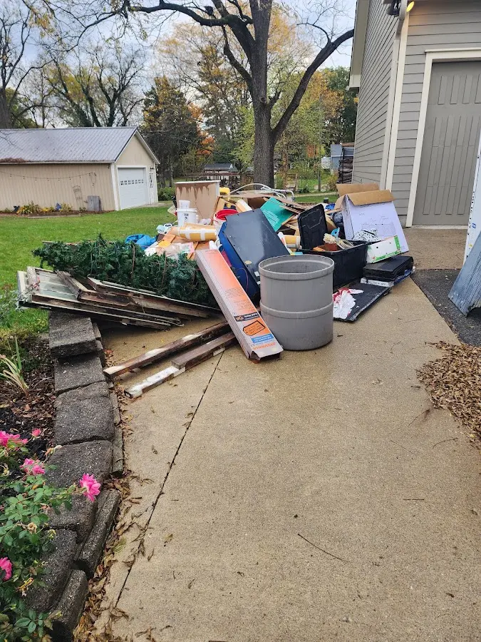 Dumpster being loaded with debris for Estate Cleanout Dumpster Rental in Estherville